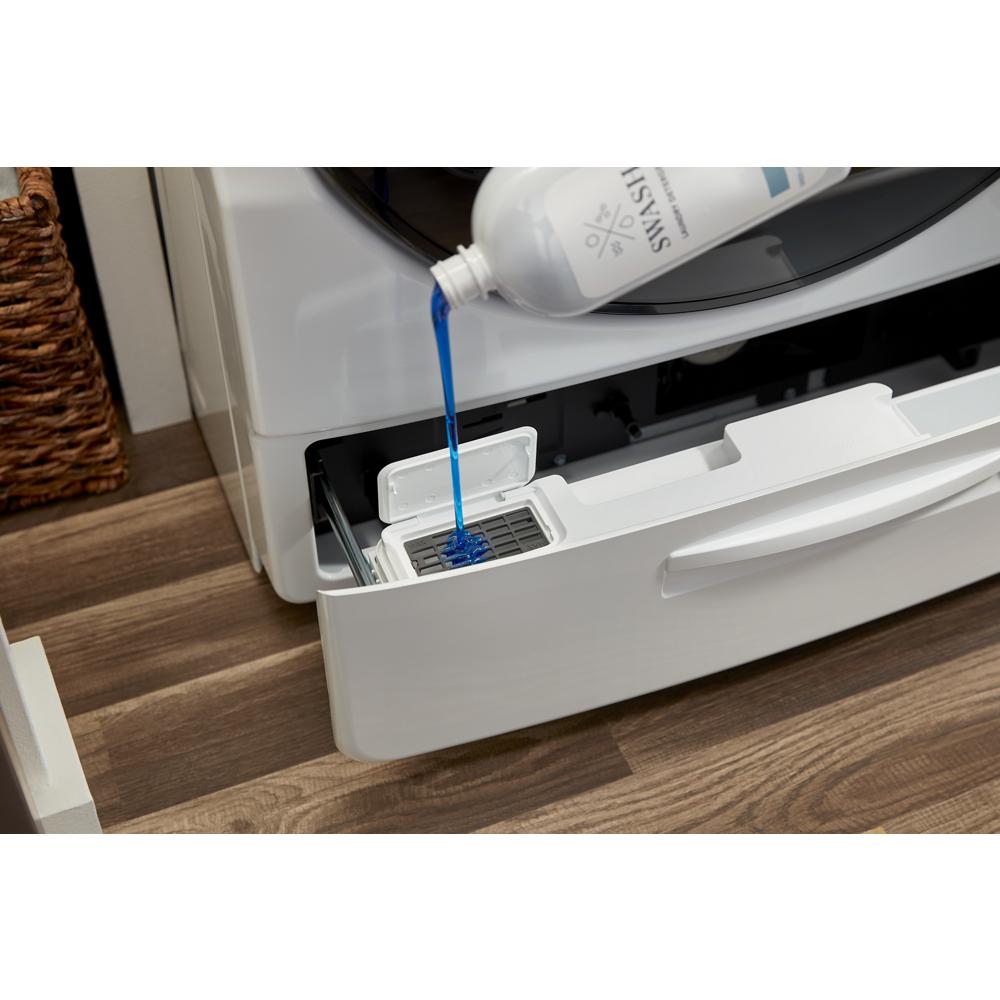 Blue liquid detergent being poured into the detergent dispenser of a white ventless washer dryer combo in a laundry room setting