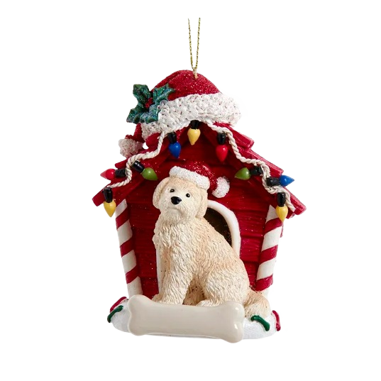Goldendoodle dog wearing Santa hat sitting in front of red dog house decorated with colorful Christmas lights
