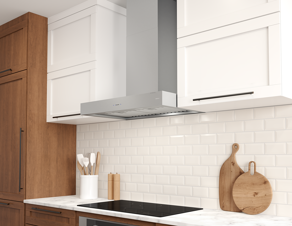 Stainless steel wall mounted range hood with sleek design above cooktop in modern kitchen with wood and white cabinetry