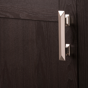 Polished nickel bungalow pull with beveled edges on dark wood cabinet in home improvement hardware setting
