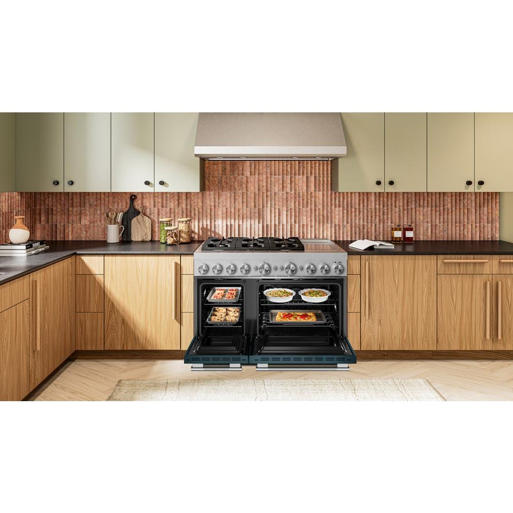 48-inch dual fuel range with six burners and open electric double ovens baking dishes in modern kitchen setting