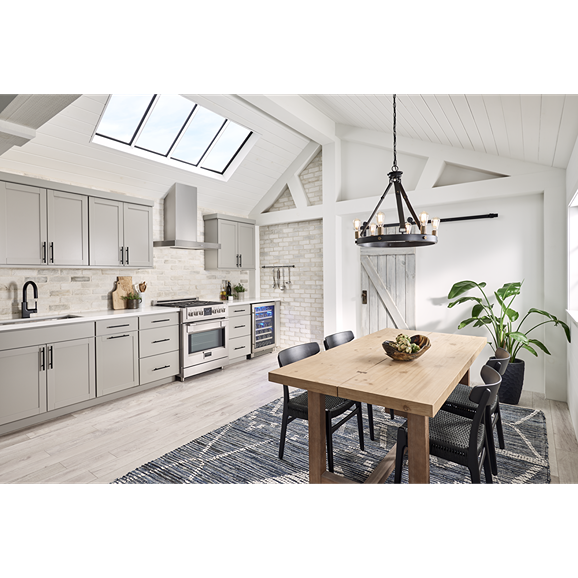 Contemporary kitchen featuring a sleek stainless steel chimney hood above a stove in a bright modern space