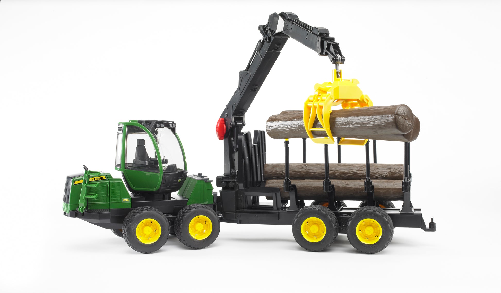 Green and yellow Bruder John Deere 1210E toy forwarder lifting wooden logs with articulated crane for home improvement play