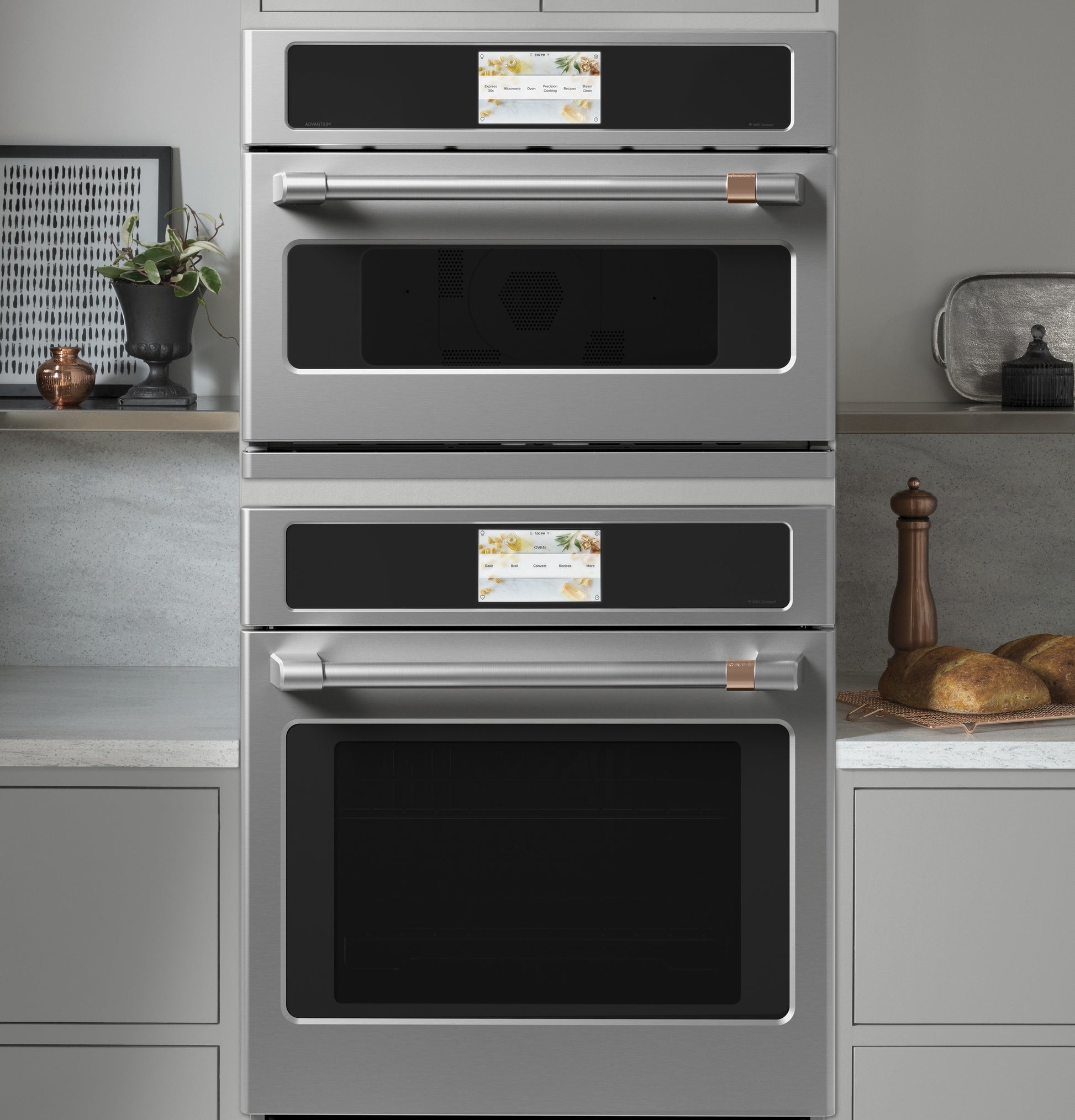 Built-in stainless steel double wall ovens with digital touch control panels in modern kitchen setting
