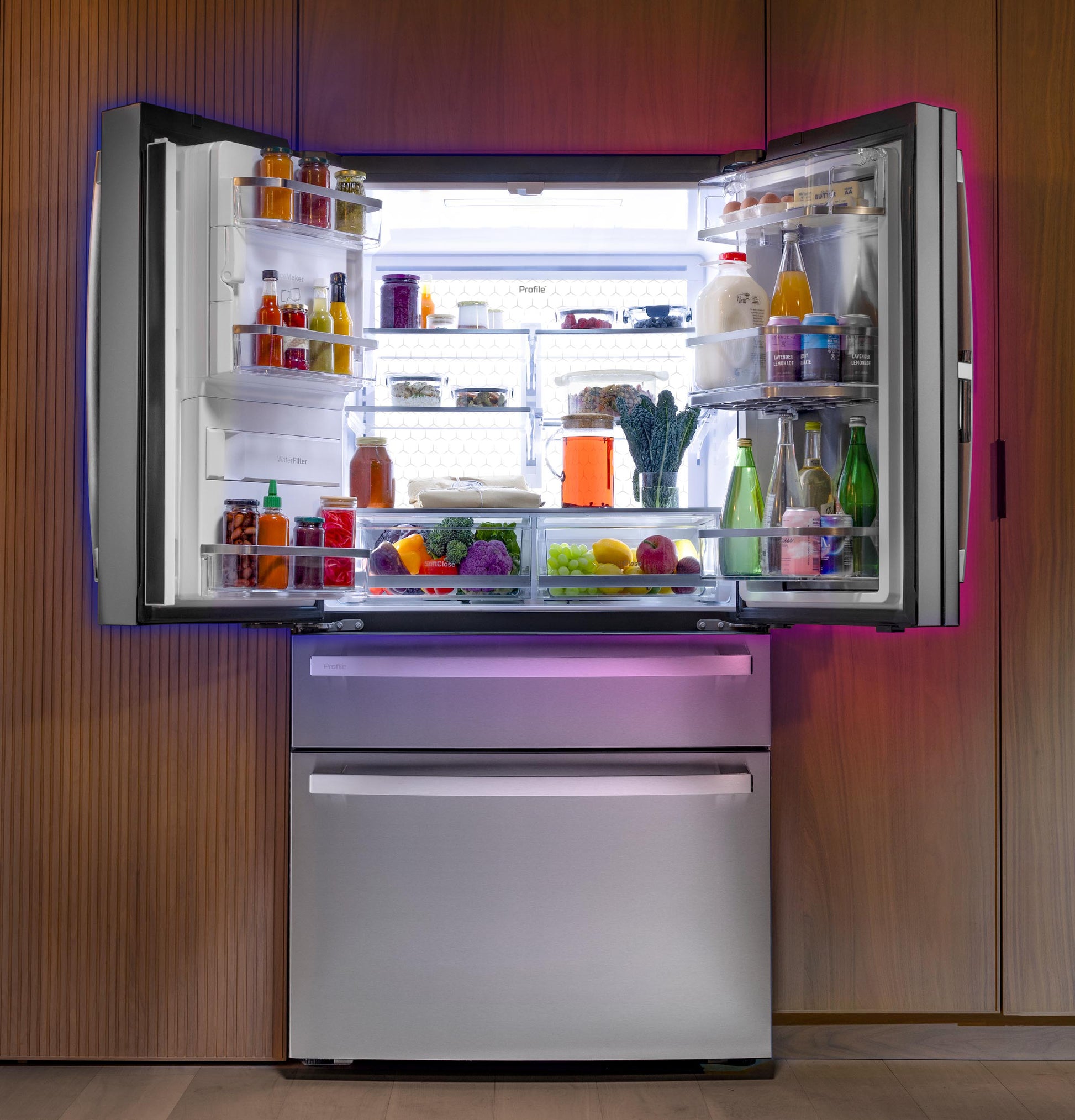 Modern stainless steel French-door refrigerator with bright interior light and organized shelves in kitchen setting