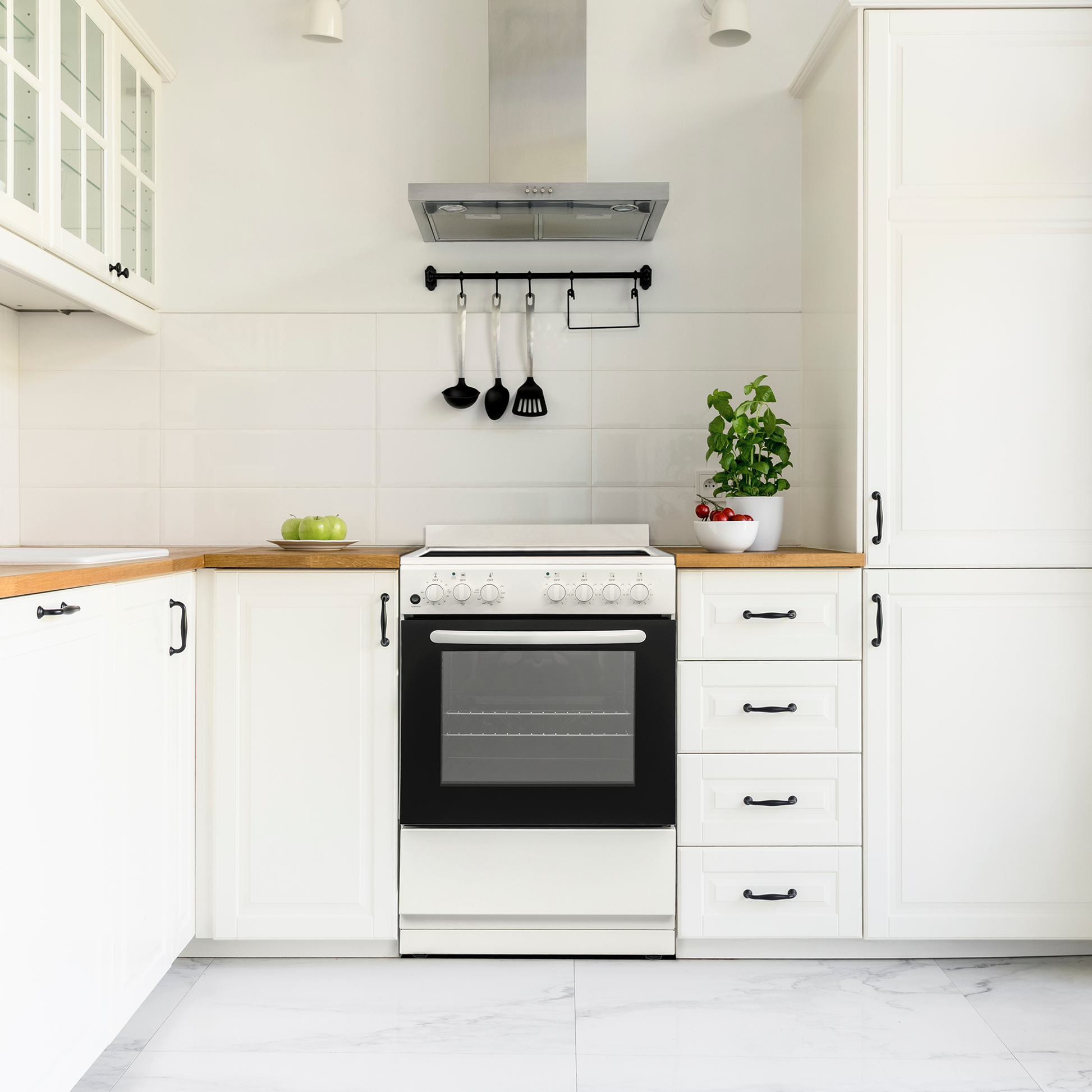 compact white electric range with black oven door and control knobs in modern kitchen with wooden countertops