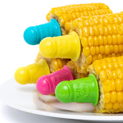 Colorful plastic corn holders in blue, yellow, pink, and green inserted into cooked corn on the cob pieces