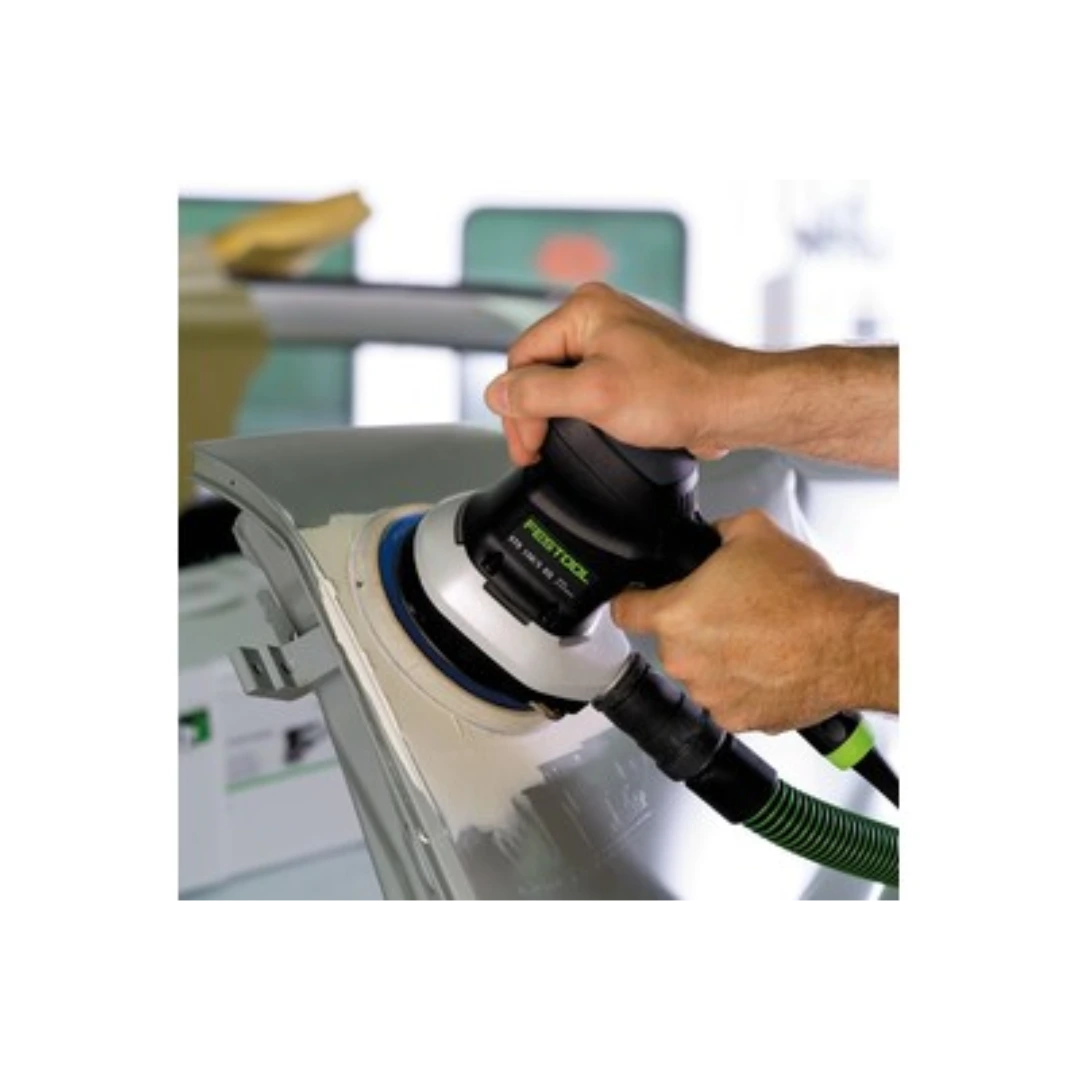Hands using Festool power sander with StickFix pad for vehicle surface smoothing in home improvement setting