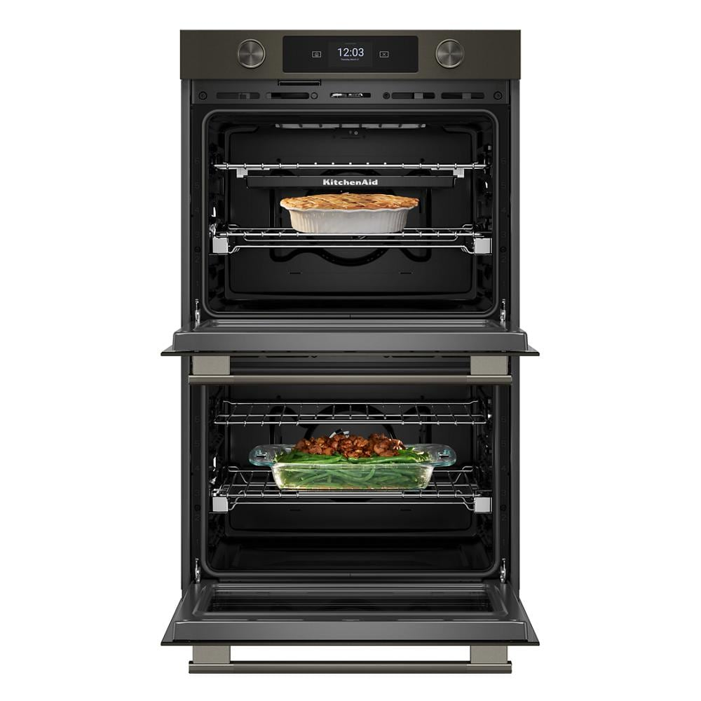 30-inch black ore double wall oven with digital display, dual interiors, and food baking inside kitchen appliance