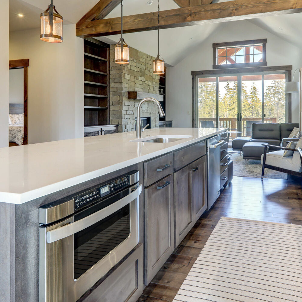 Modern kitchen interior featuring built-in microwave drawer with stainless steel finish and wood cabinetry in appliances collection