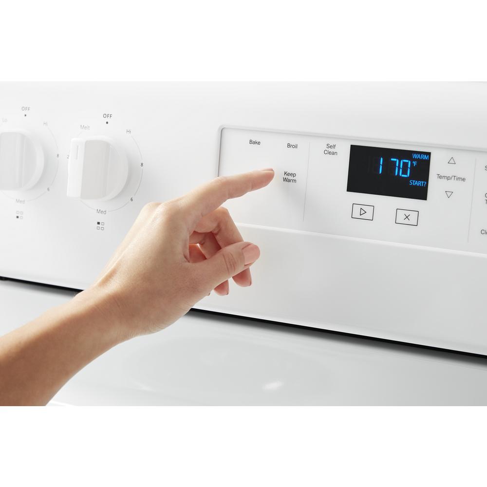 Finger pressing digital control panel displaying 170 degrees on white electric range from Ranges collection