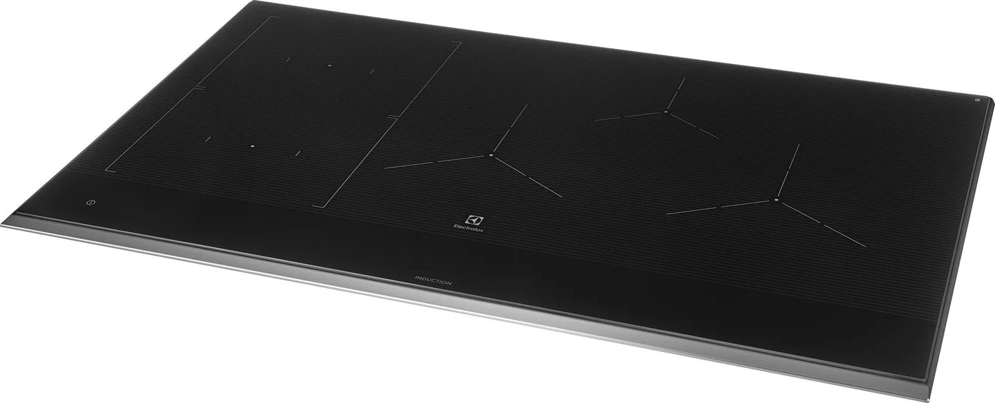 Sleek black glass 36-inch induction cooktop with multiple heating zones for modern kitchen appliances and cooktops collection