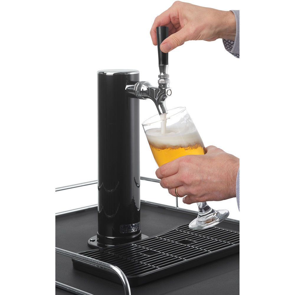 Close-up of hands pouring beer from a black tap tower on a keg cooler in kitchen appliance setting