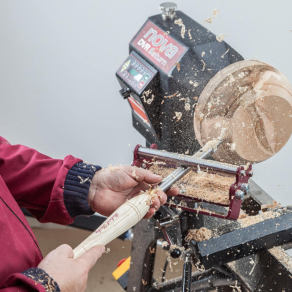 Woodturning lathe with Sorby SteadyPro system supporting a wooden bowl being shaped with a turning tool
