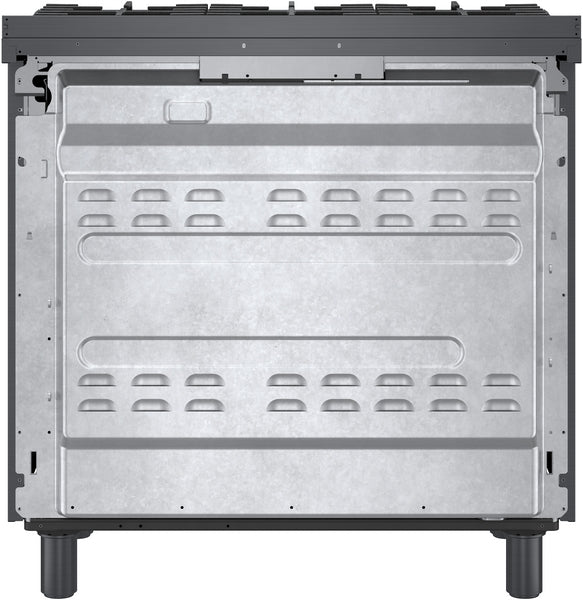 Interior view of a freestanding dual fuel range showing metal oven cavity and adjustable legs for installation in kitchen appliances collection