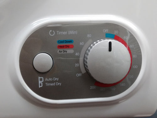Control panel of a compact dryer featuring a timer dial and options for Cool Down, Heat Dry, and Air Dry in appliance collections