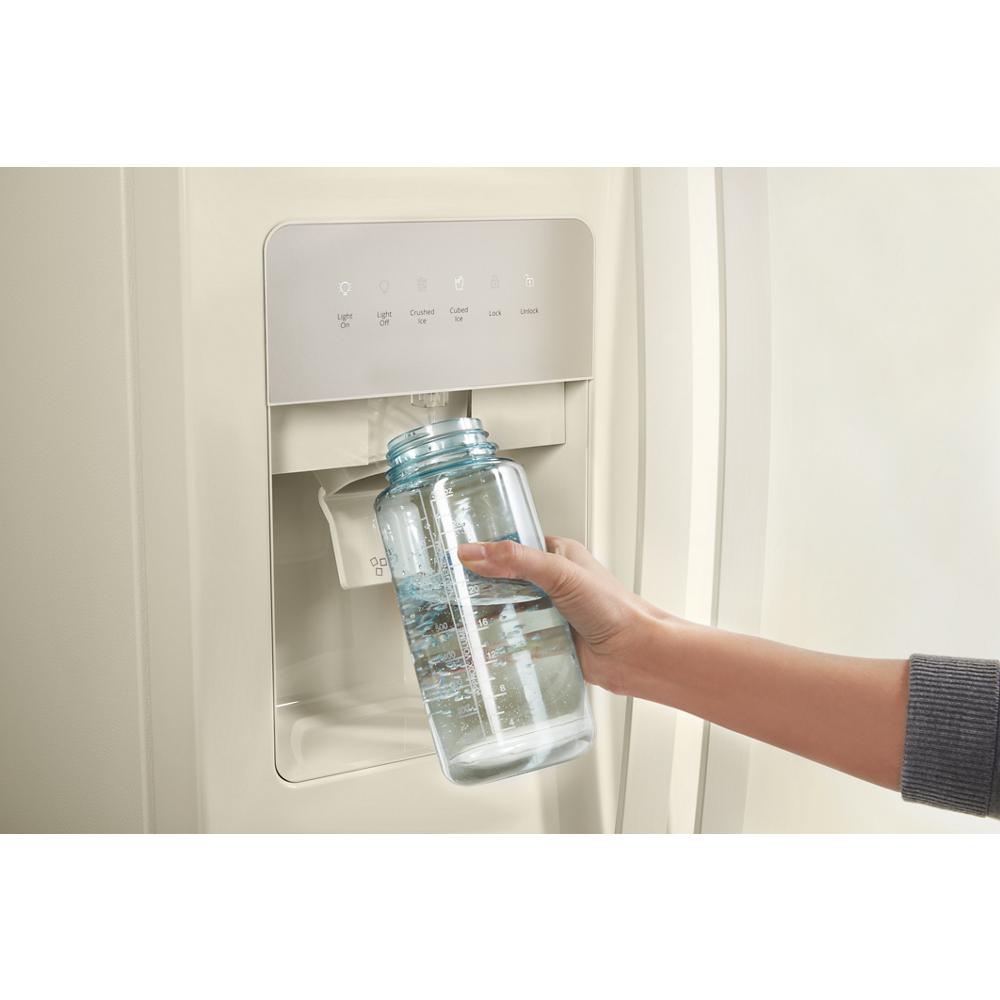 Hand filling clear water bottle from dispenser on off-white side-by-side refrigerator in kitchen appliances collection