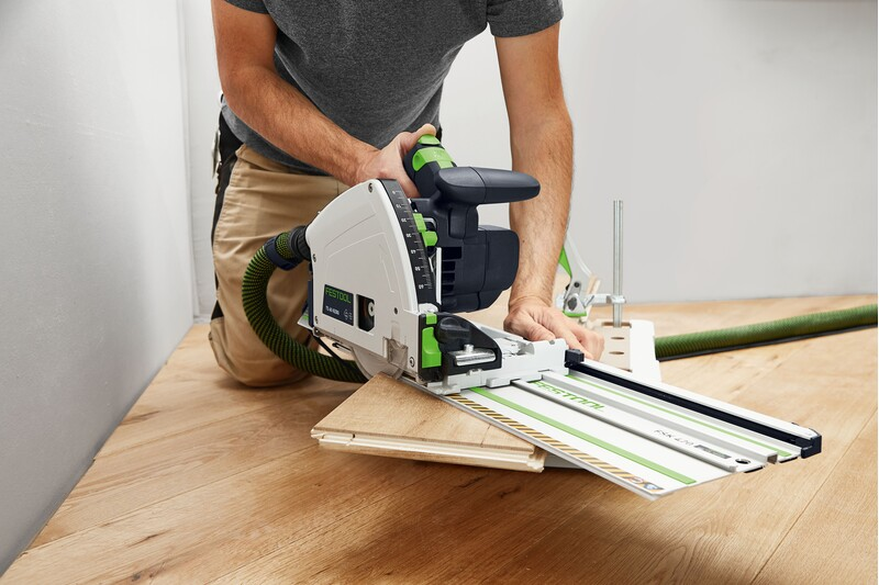 Person using Festool guide rail system with carpentry saw for precise woodworking cross-cuts in power tool accessories collection