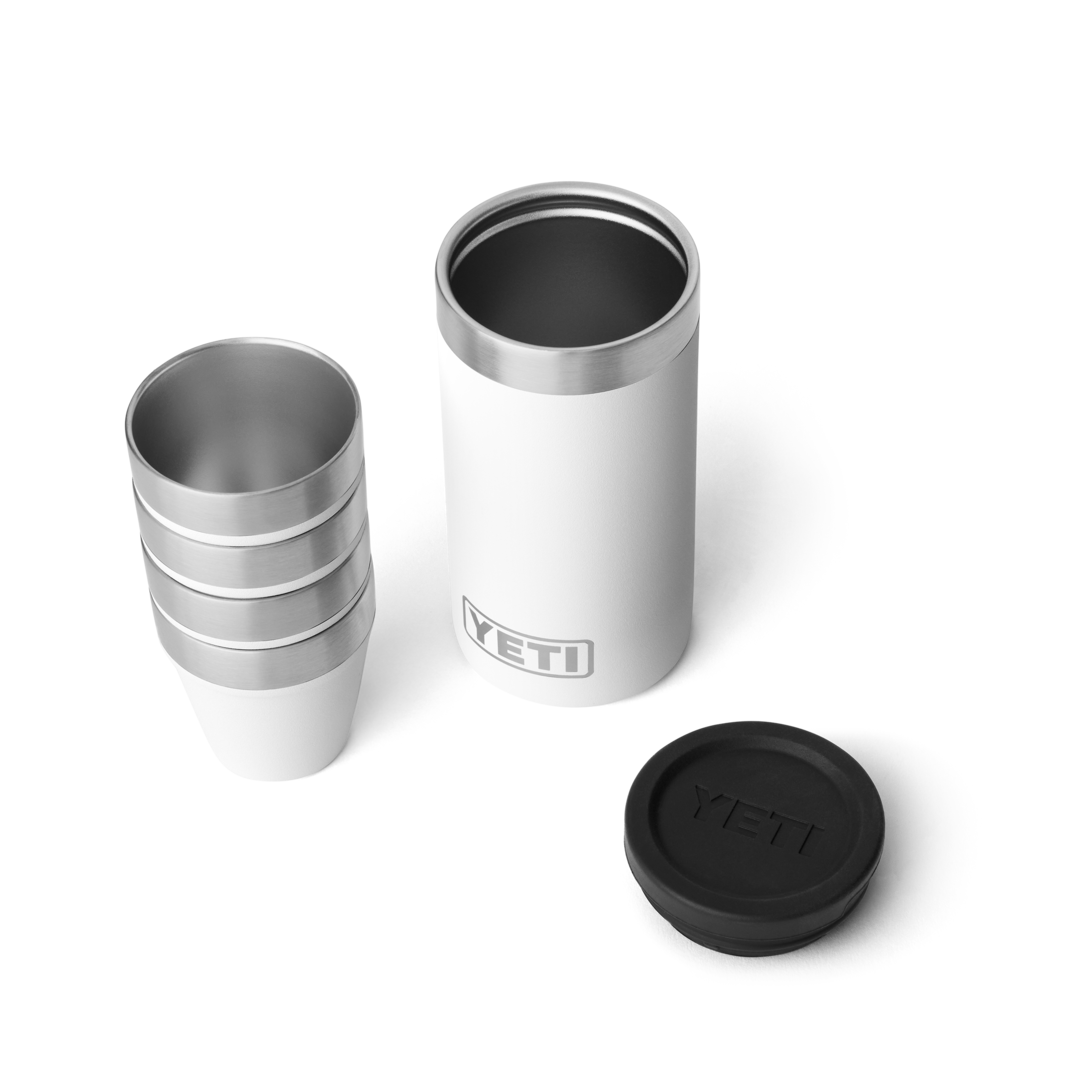 Stacked stainless steel shot glasses with white insulated carrying case and black lid for outdoor drinkware use