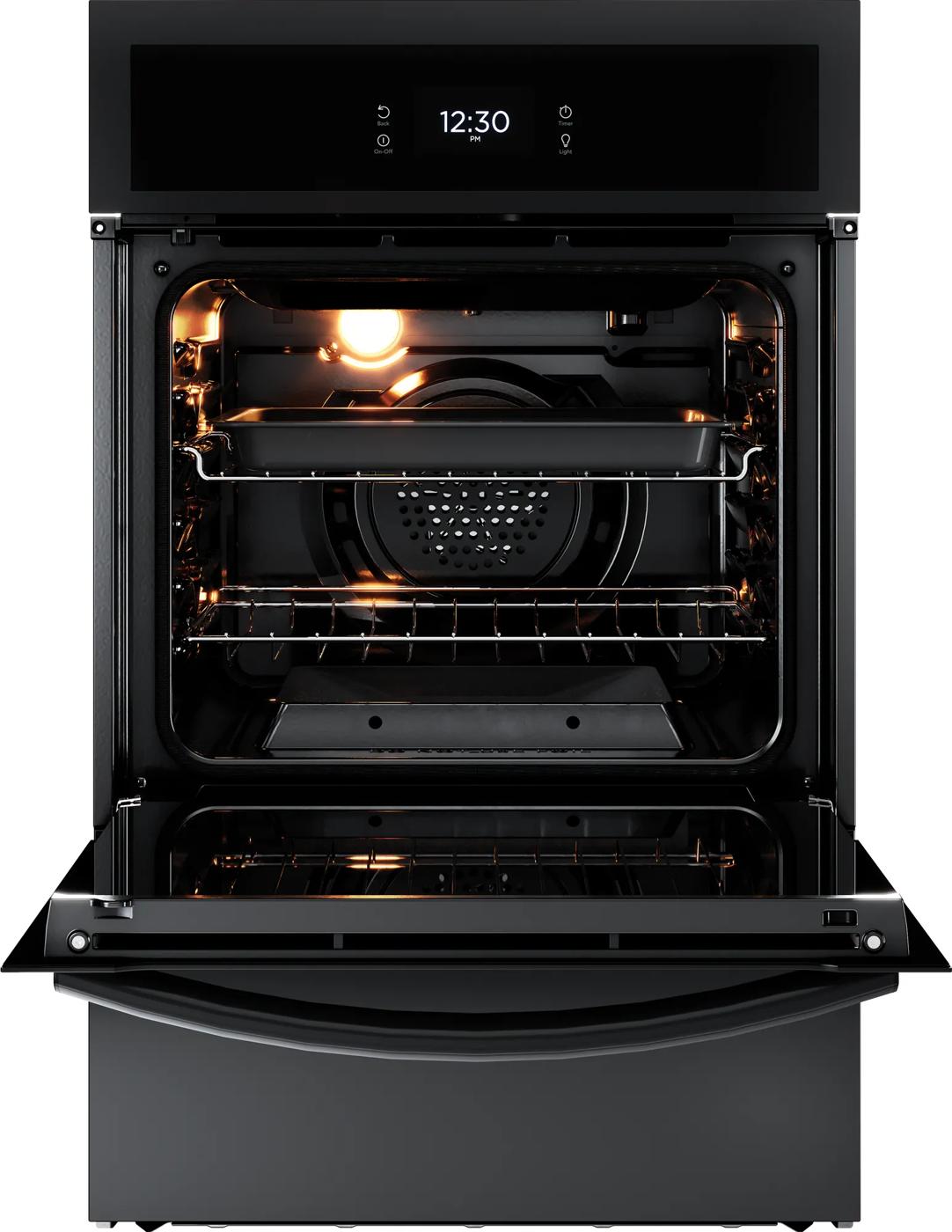 Open black single gas wall oven with interior light, racks, and digital clock display on control panel