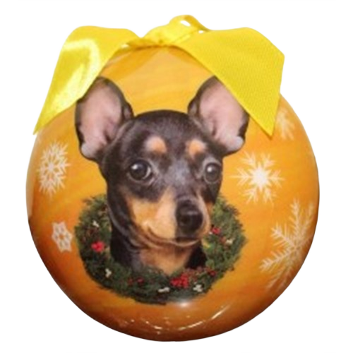 Christmas ornament featuring a black Chihuahua portrait surrounded by wreath and snowflakes with yellow bow topper