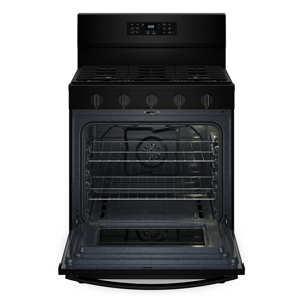 Black gas range oven open showing multiple racks and interior fan for even air baking in kitchen appliance collection