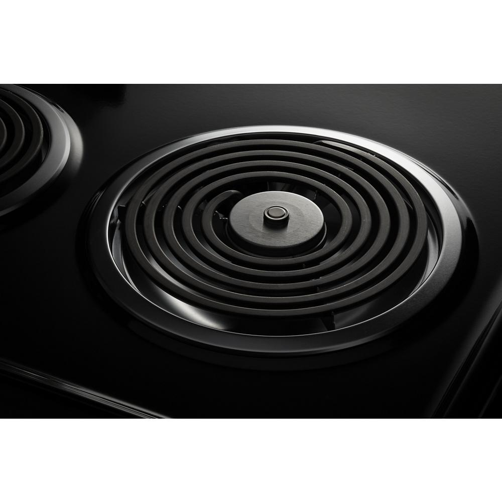 Close-up of the electric coil burner on a black cooktop surface, part of ranges and kitchenware appliances for home improvement.