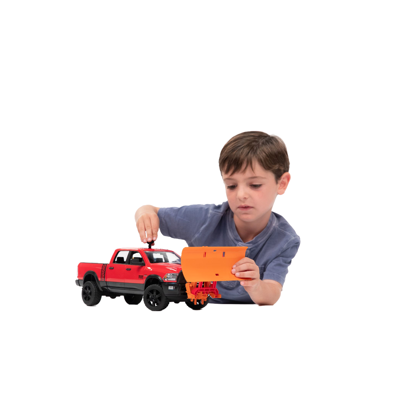 Young boy attaching an orange Bruder Toys plow blade to a red toy truck from Vehicles & Remote Controlled Toys collection