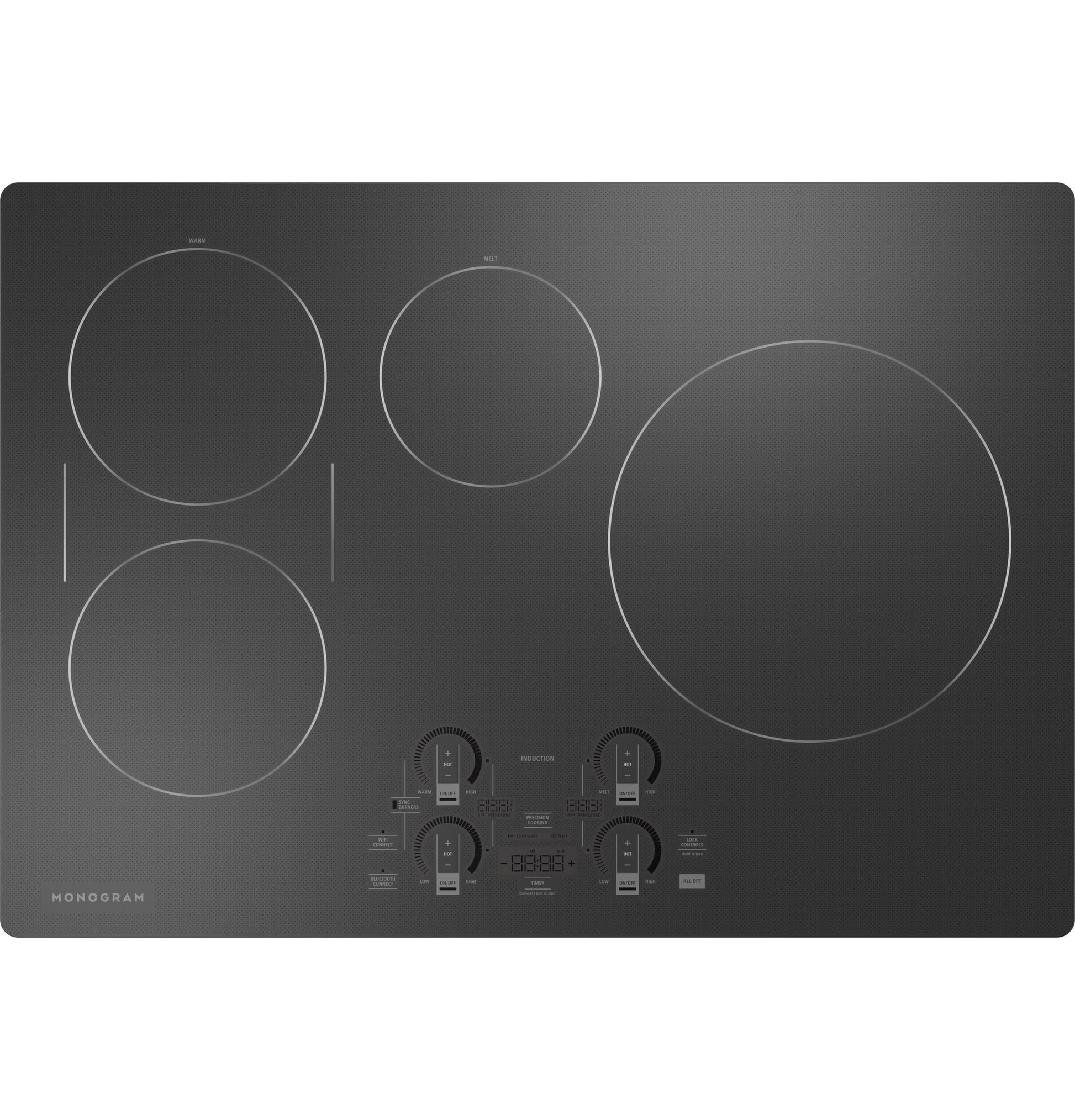 Black smooth glass induction cooktop with four cooking zones and digital touch controls in kitchen appliances collection