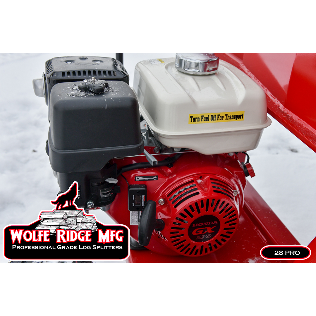 Close-up of red and white Honda gas engine mounted on a Wolfe Ridge log splitter in snowy outdoor setting