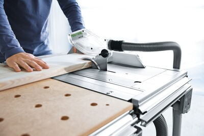 Woodworker using Festool track saw on multifunction table for precise cutting in woodworking tools and tool stands collections