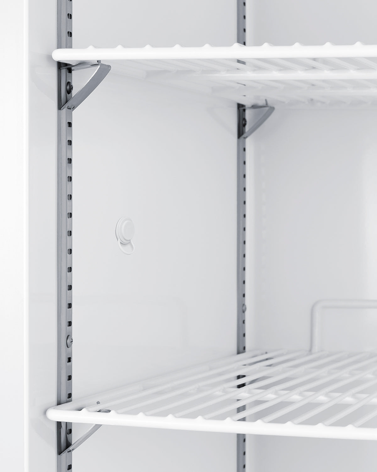 Close-up of white wire shelves inside an upright freezer designed for laboratory and clinical storage use