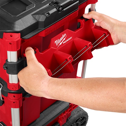 Red Milwaukee PACKOUT™ long tool holder attachment being secured to modular storage for workshop organization.