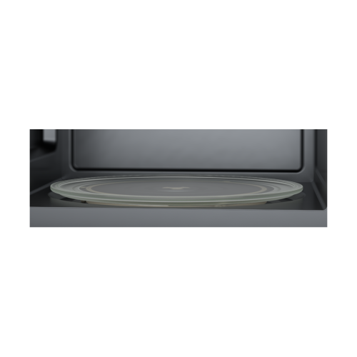 Interior view of a microwave oven showcasing a glass turntable plate for even cooking in kitchen appliances.
