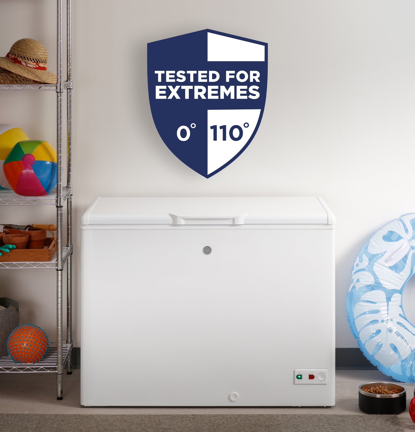 White manual defrost chest freezer in room setting with temperature-tested badge and shelves with toys nearby