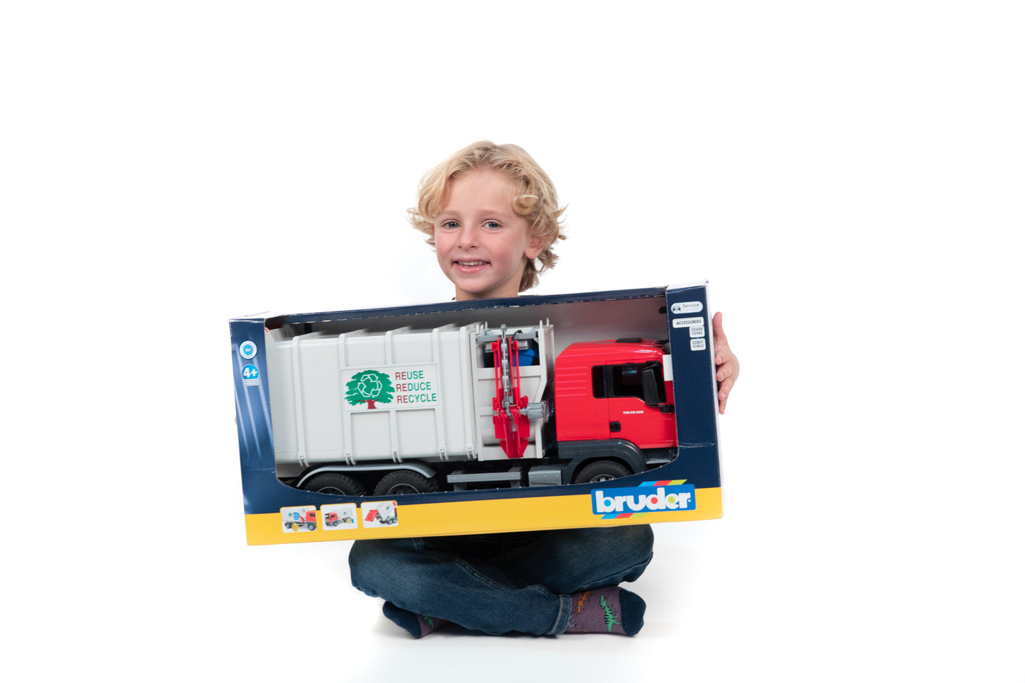 Child holding Bruder Man Tgs side loading garbage truck toy from Vehicles & Remote Controlled Toys collection