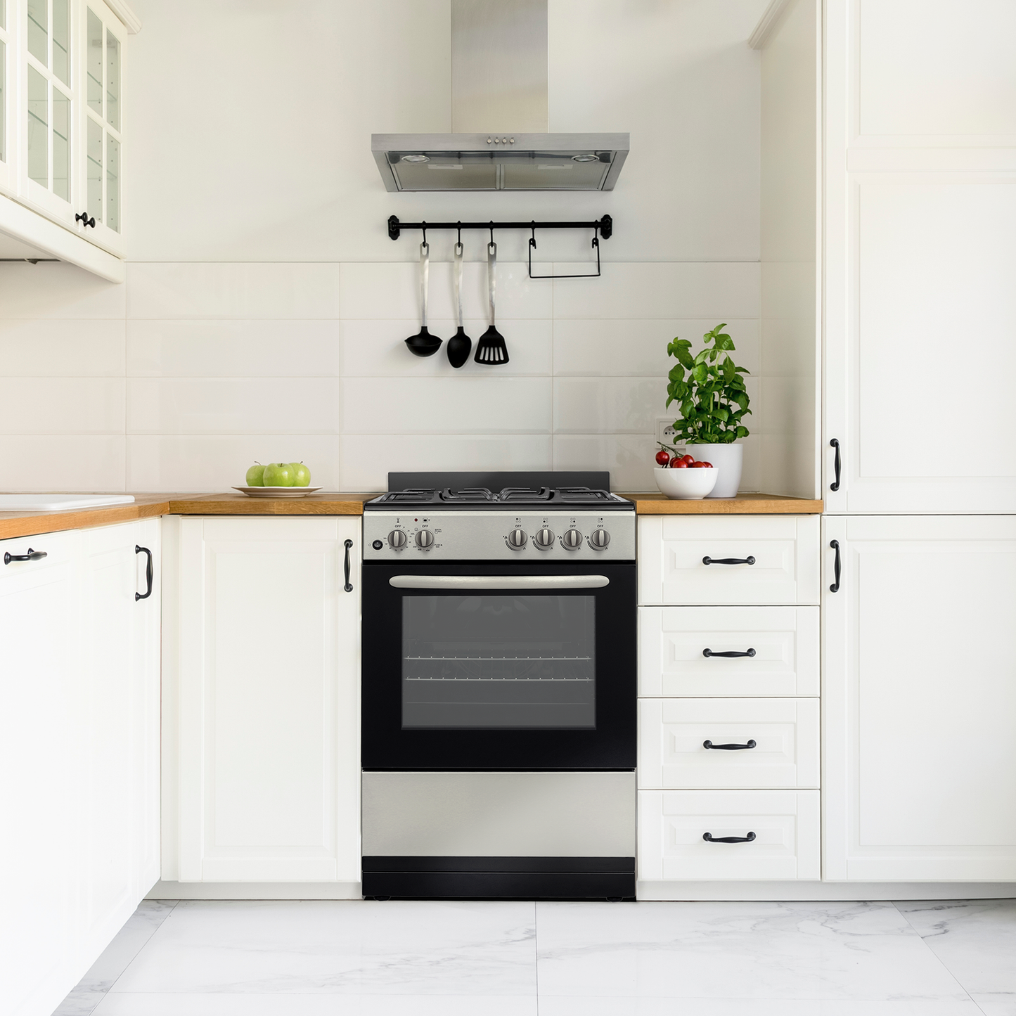 24-inch stainless steel gas range with control knobs, oven window, and modern white kitchen cabinetry from gas ranges collection