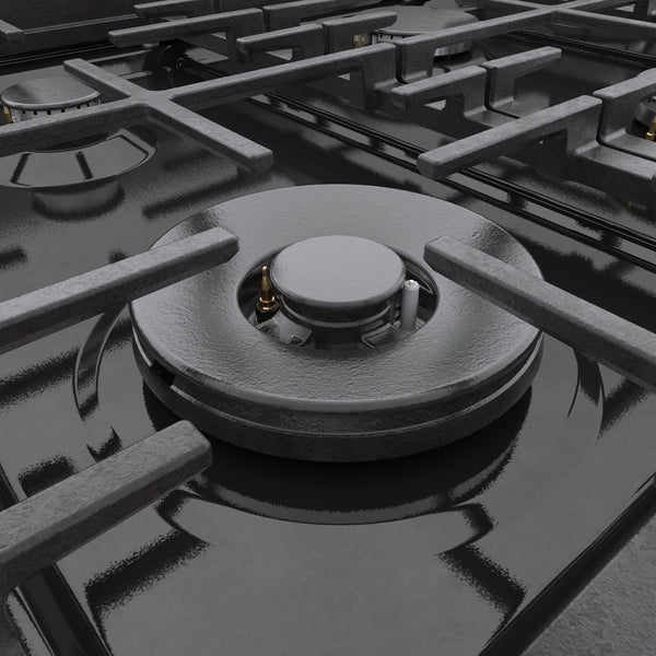 Close-up of a black porcelain-enameled gas burner with cast iron grates on a kitchen range surface