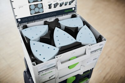 Organized white Systainer case with blue delta-shaped abrasives for woodworking tool storage and workshop organization