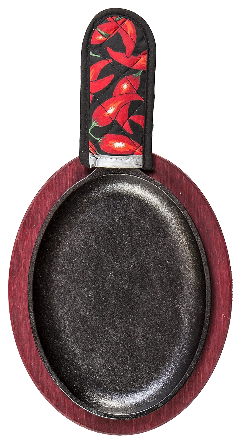 Oval cast iron skillet on wooden serving platter with chili pepper-patterned handle cover in kitchenware collection