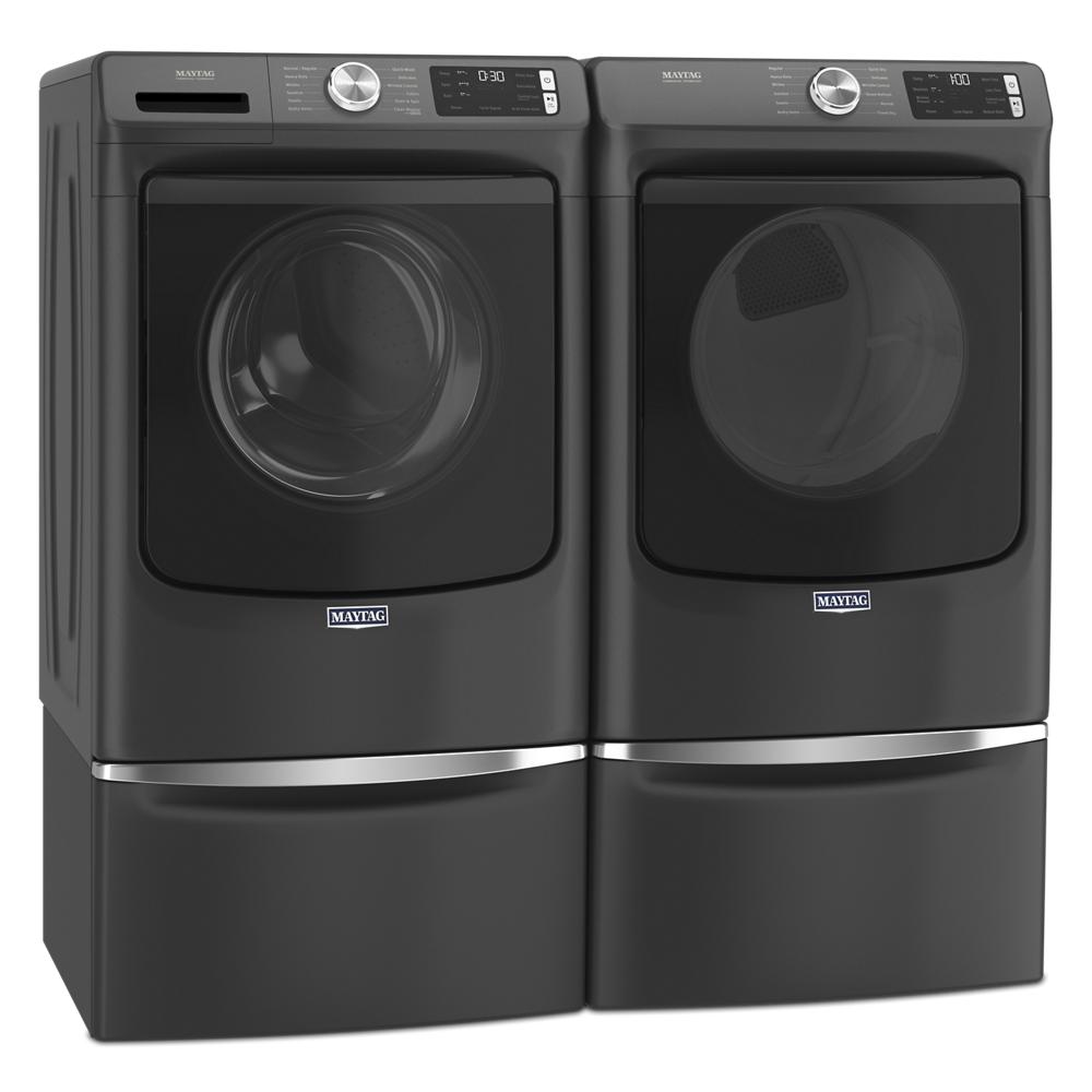 Set of black front load washer and electric dryer with pedestal bases and digital controls in modern appliance collection