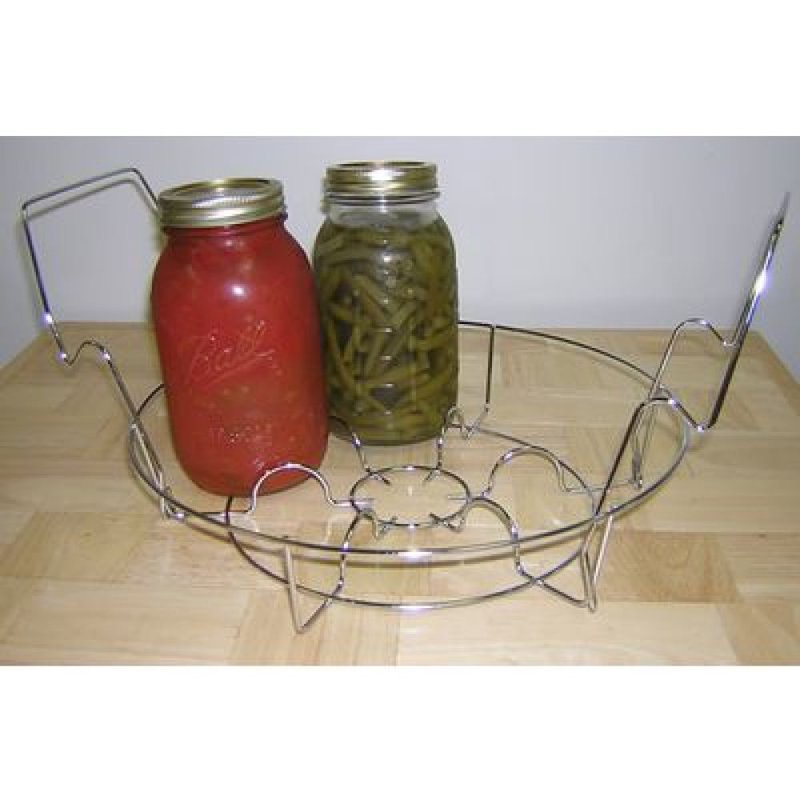 Chrome wire rack with circular base and handles holding two sealed glass jars filled with preserved food items