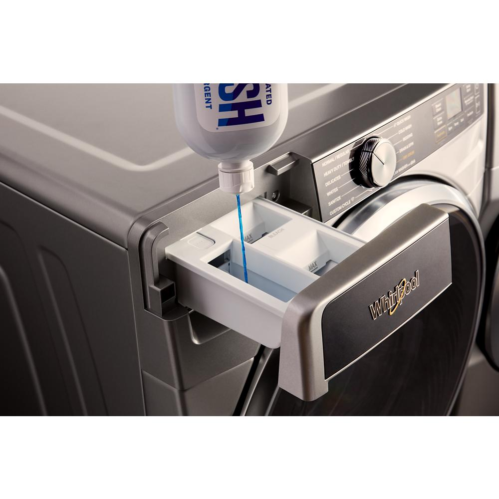 Silver front load washer with detergent compartment open and liquid detergent being poured in for washing cycle