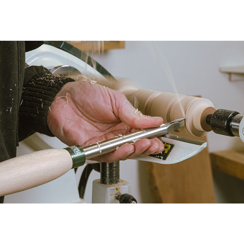 Woodturning tool with diamond carbide tip and 12-inch ProComfort handle shaping rotating wood on lathe for home improvement tasks