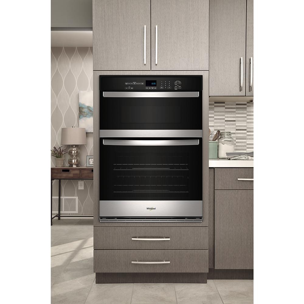 Built-in microwave and wall oven combo with digital controls and stainless steel accents in modern kitchen setting