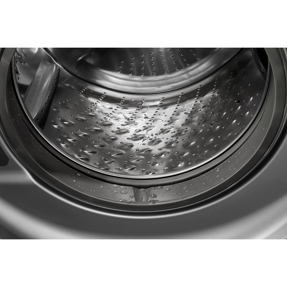 Close-up of stainless steel drum interior with water droplets inside a front load washer from washers & dryers category