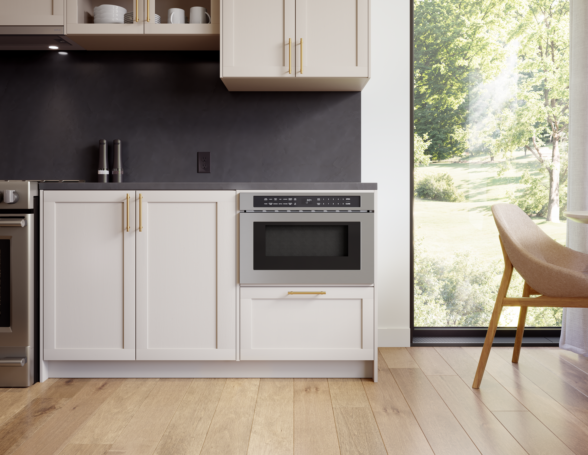 built-in stainless steel microwave drawer integrated in modern kitchen cabinetry near large window in home appliances collection