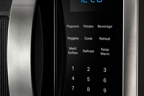 Close-up of stainless steel over-the-range microwave control panel showing sensor cooking options and numeric keypad