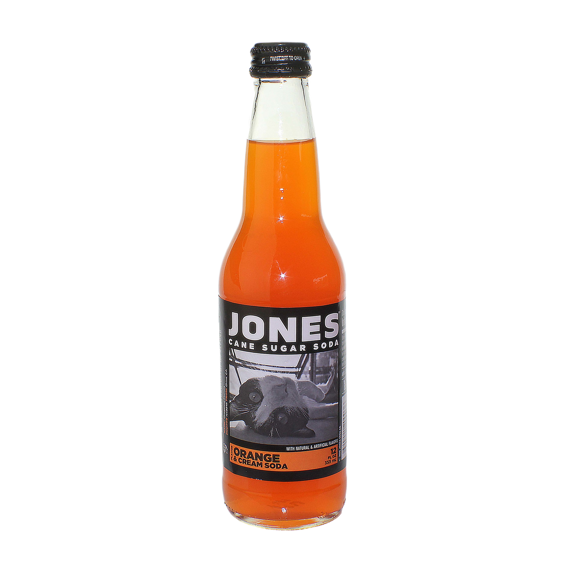 Glass bottle of Jones orange and cream soda with black and white label featuring a cow image