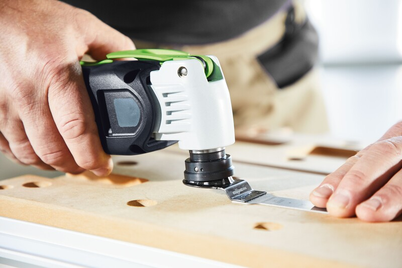 Person using a compact oscillating tool with a Japanese style wood saw blade for detailed woodworking tasks